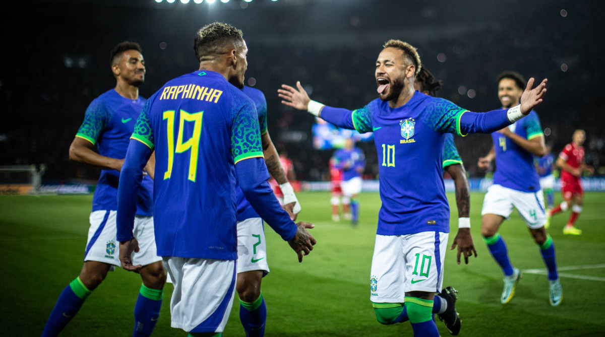 Brazil celebrating a goal vs. Tunisia.